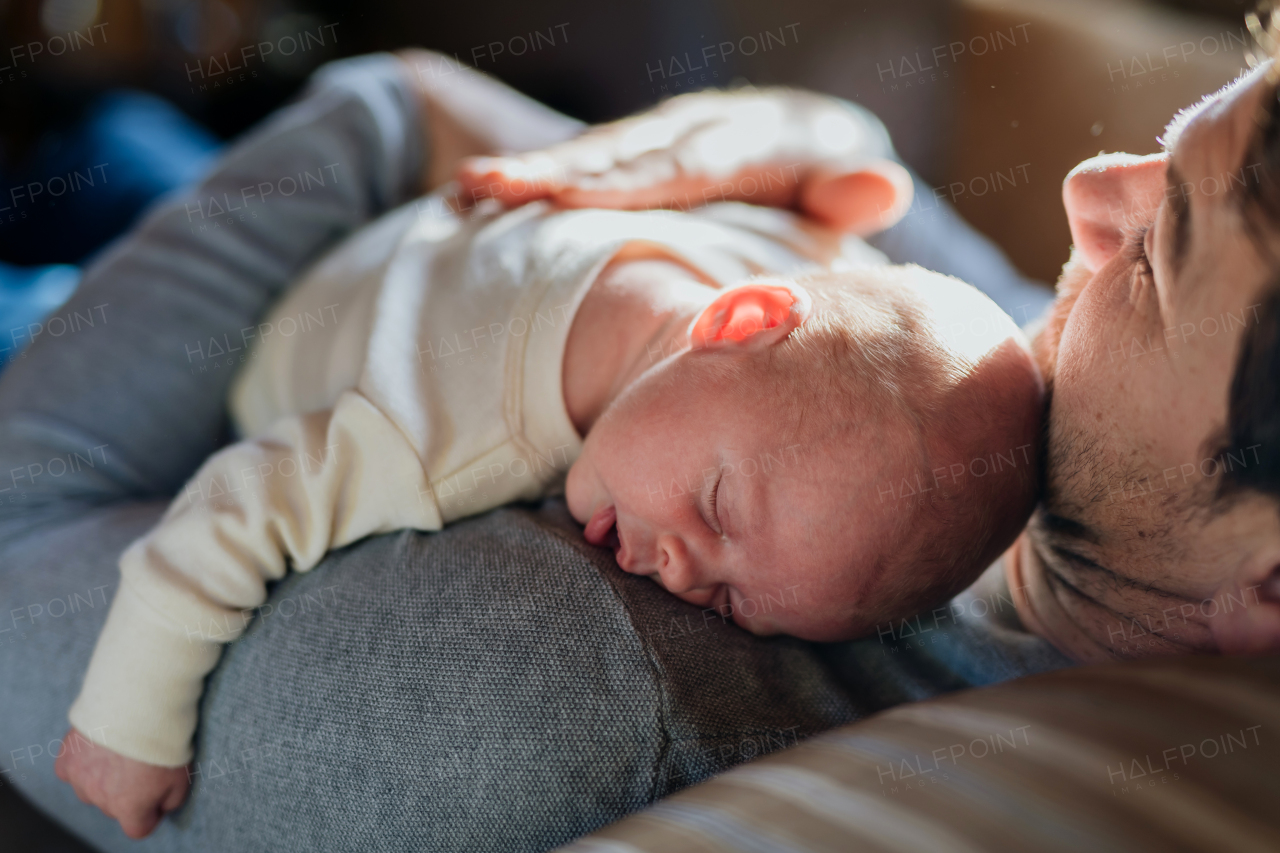 Close-up of father holding his little new born baby.