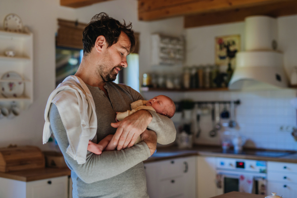 Close-up of father holding his little new born baby.