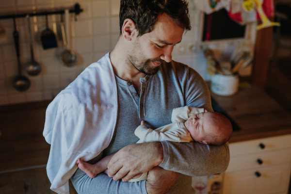 Close-up of father holding his little new born baby.