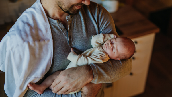 Close-up of father holding his little new born baby.