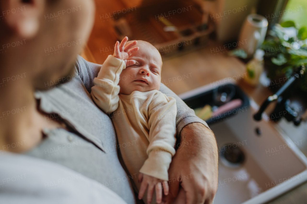 Close-up of father holding his little new born baby.