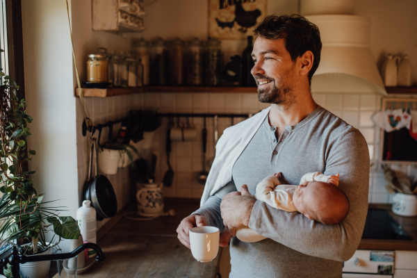 Close-up of father holding his little new born baby.