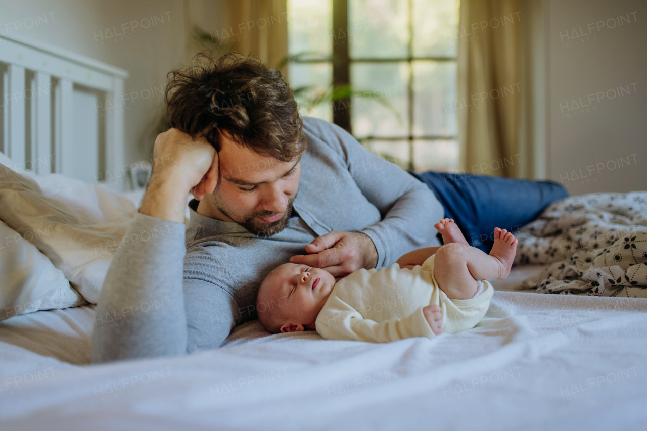 Close-up of father cuddling his little new born baby.