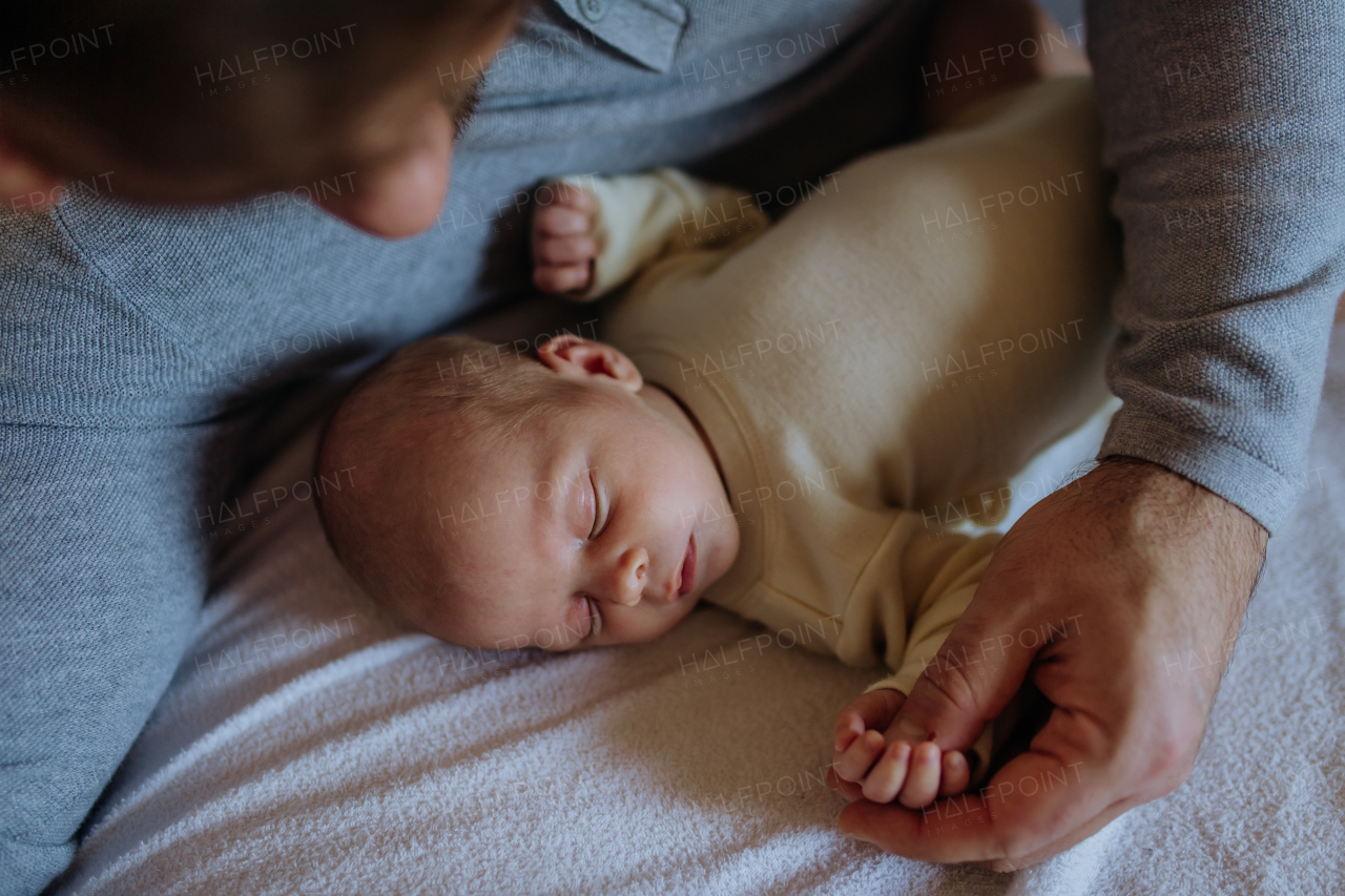 Close-up of father cuddling his little new born baby.