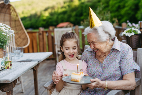 Granddaughter taking selfie with elderly grandma, companionship. Senior lady spending time with young girl, enjoying together time. Weekend in cottage.