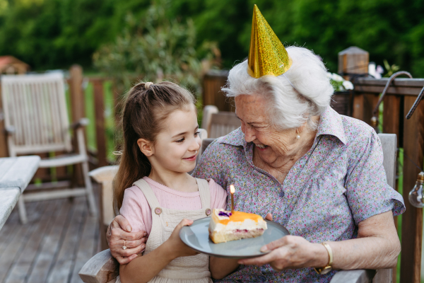 Granddaughter taking selfie with elderly grandma, companionship. Senior lady spending time with young girl, enjoying together time. Weekend in cottage.