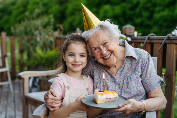 Granddaughter taking selfie with elderly grandma, companionship. Senior lady spending time with young girl, enjoying together time. Weekend in cottage.