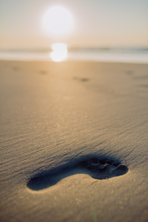 Close-up of a footprint on a beach.