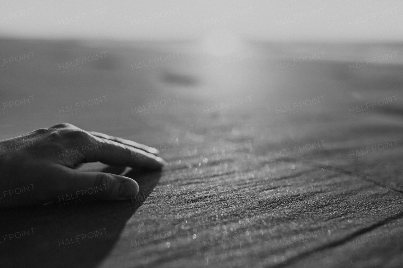 Close-up of a hand on a beach.