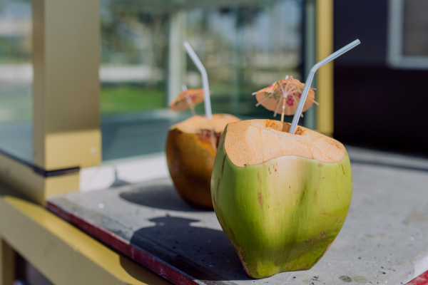 Close-up of fresh coconuts with the straw.