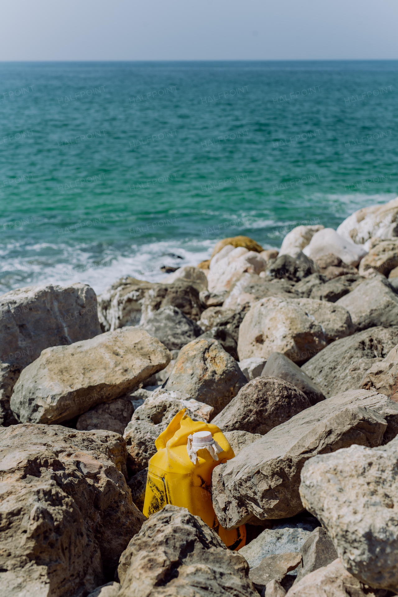 Garbare on stone beach, near the ocean.