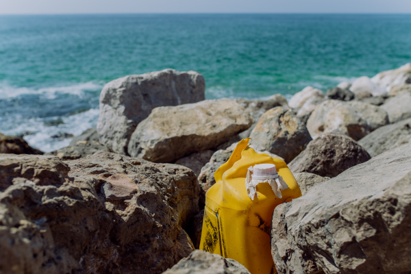 Garbare on stone beach, near the ocean.