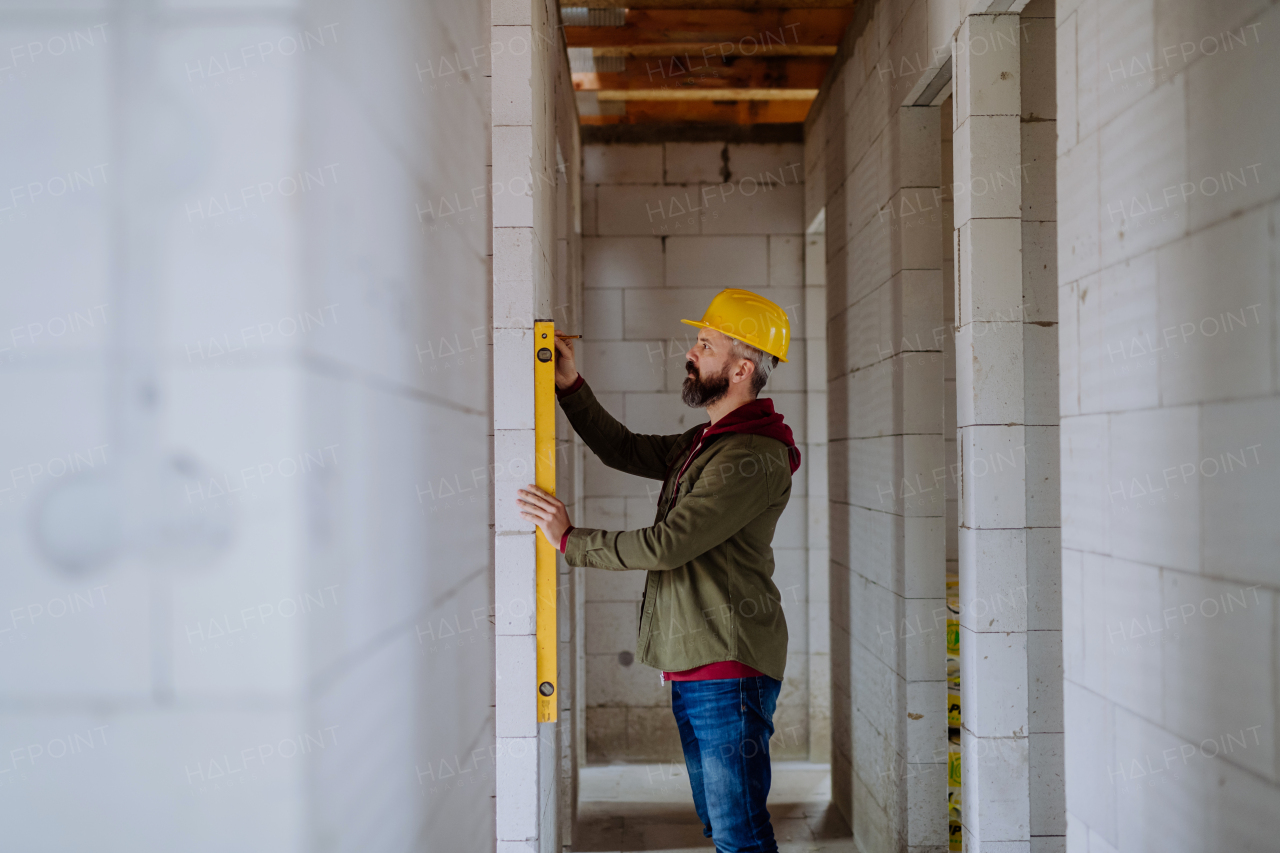 Portrait of mature man working in his new unfinished house.