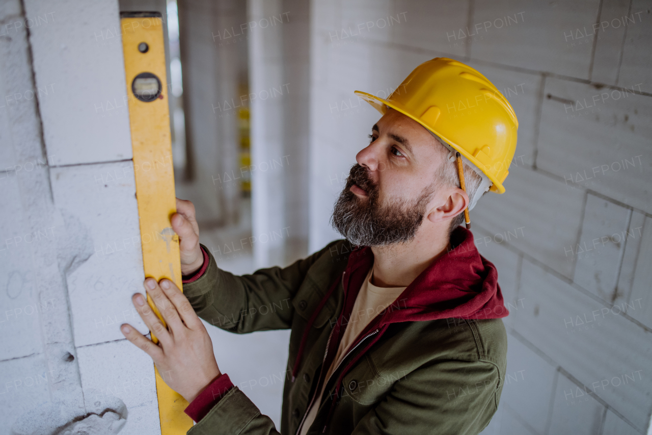 Portrait of mature man working in his new unfinished house.