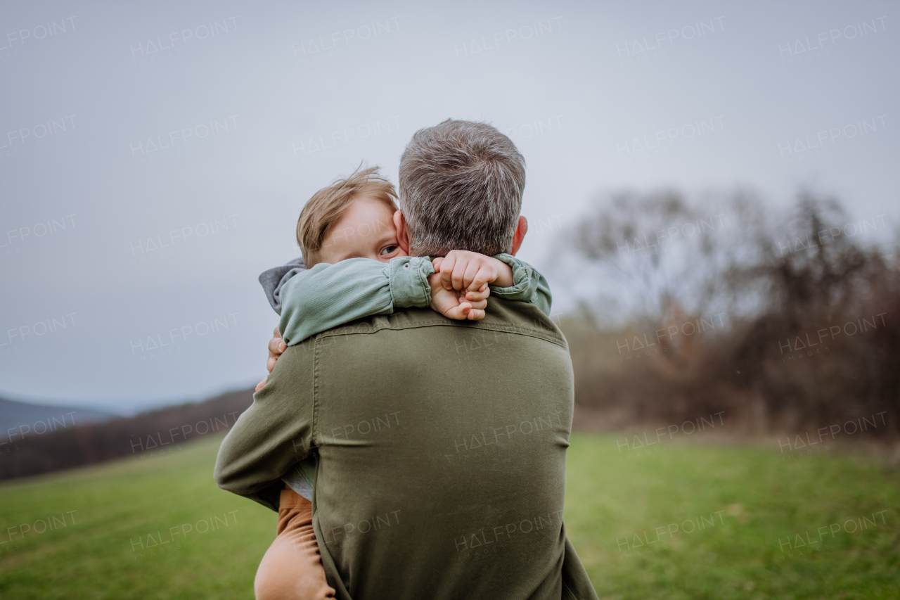 Father and his little son on a walk in the nature.