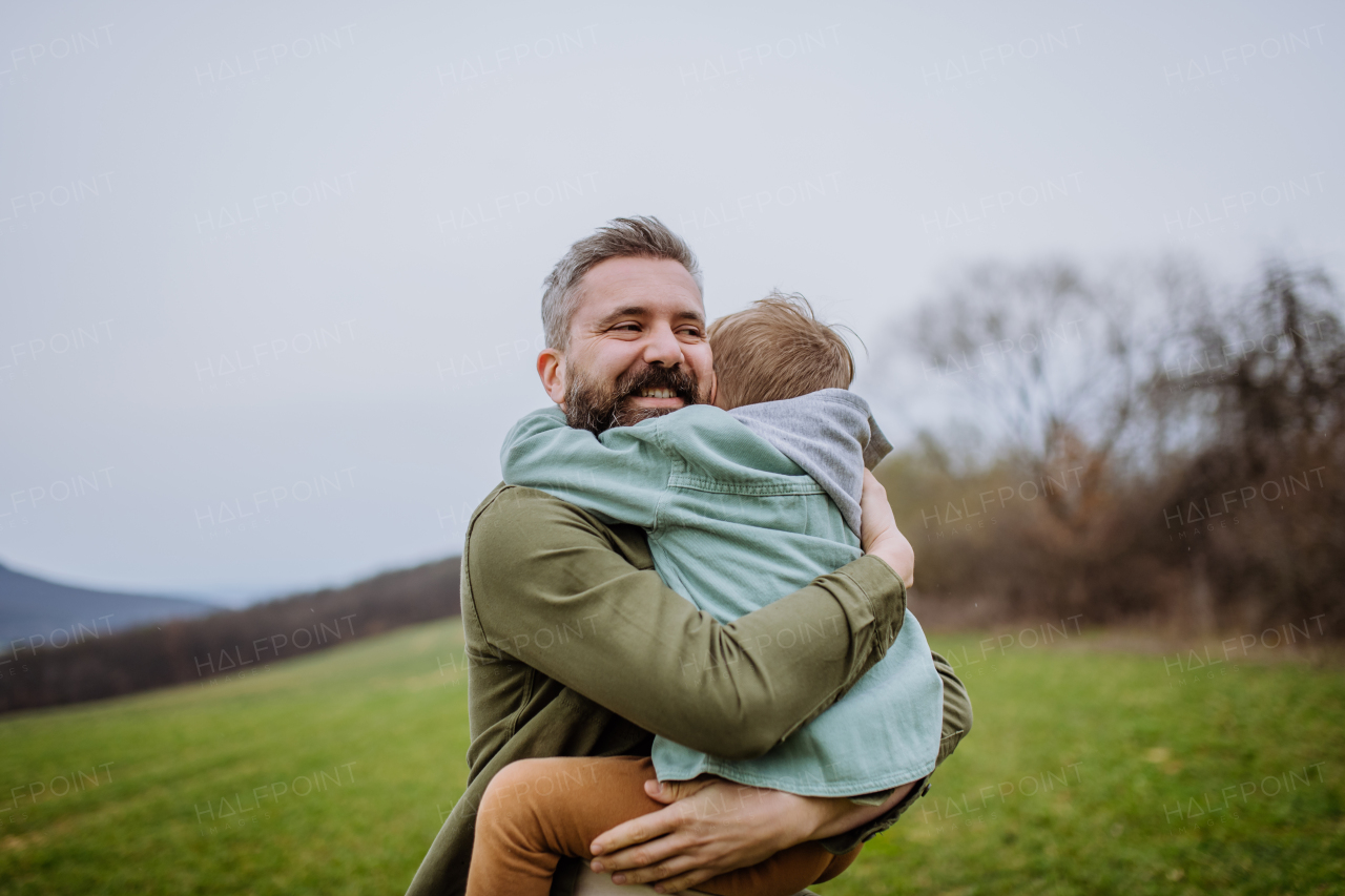 Father and his little son on a walk in the nature.