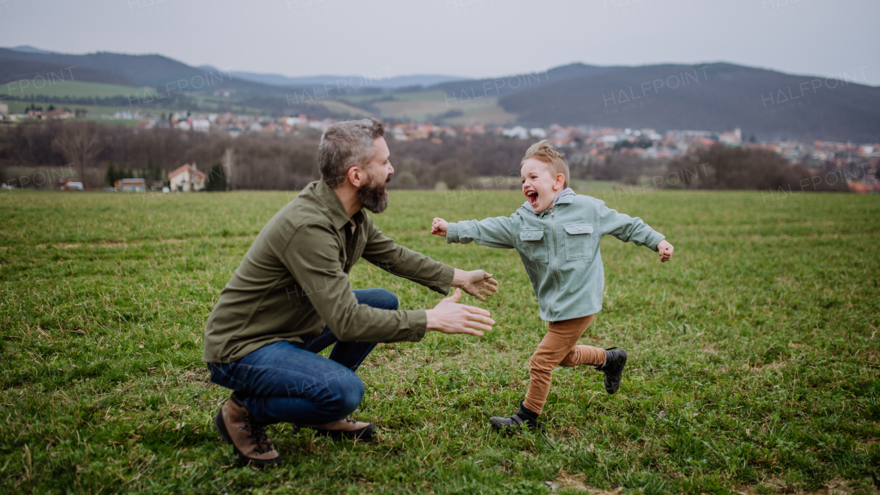 Father and his little son on a walk in the nature.