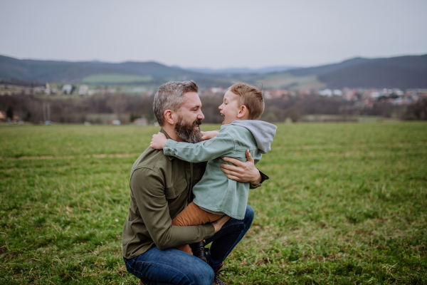 Father and his little son on a walk in the nature.