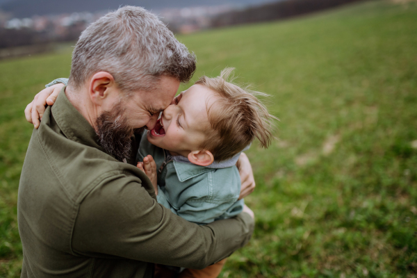 Father and his little son on a walk in the nature.