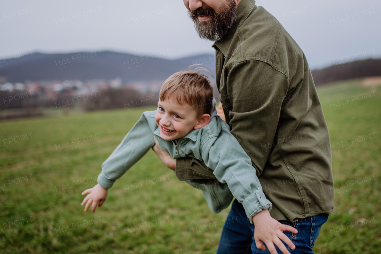 Father and his little son on a walk in the nature.