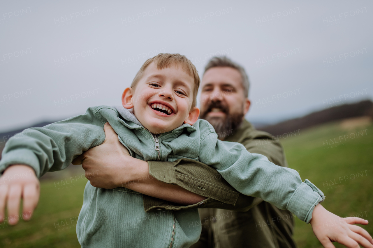 Father and his little son on a walk in the nature.