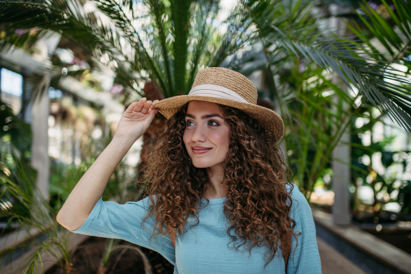 Portrait of young beautiful woman in botanical garden.