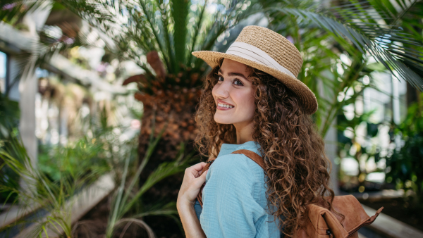 Portrait of young beautiful woman in botanical garden.