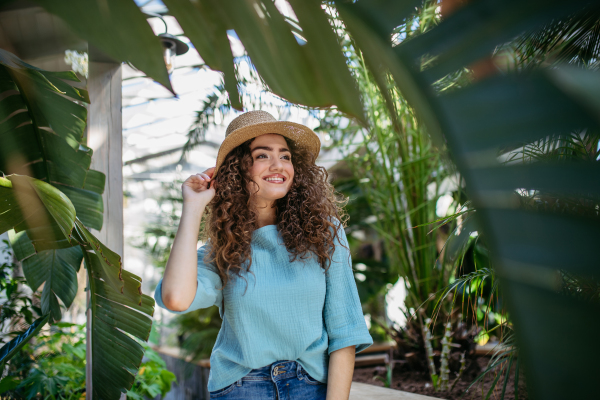 Portrait of young beautiful woman in botanical garden.