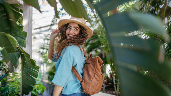 Portrait of young beautiful woman in botanical garden.