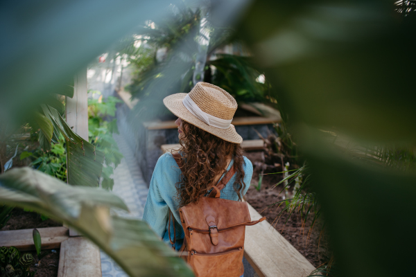 Portrait of young beautiful woman in botanical garden.