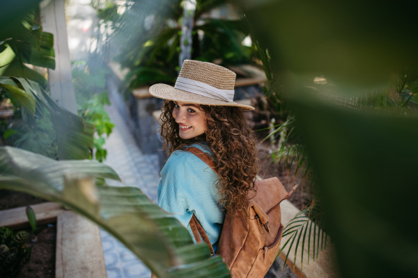 Portrait of young beautiful woman in botanical garden.