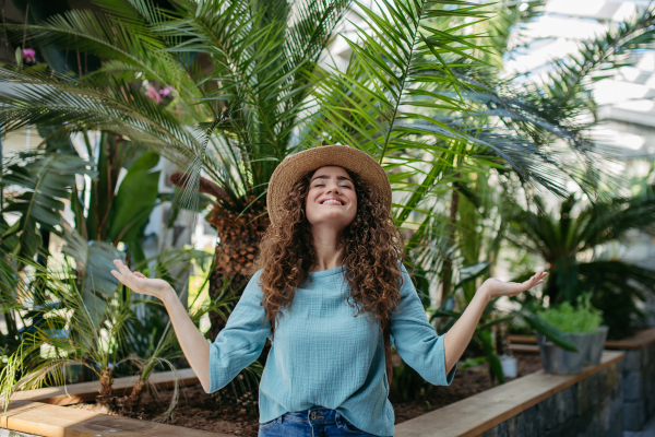 Portrait of young beautiful woman in botanical garden.