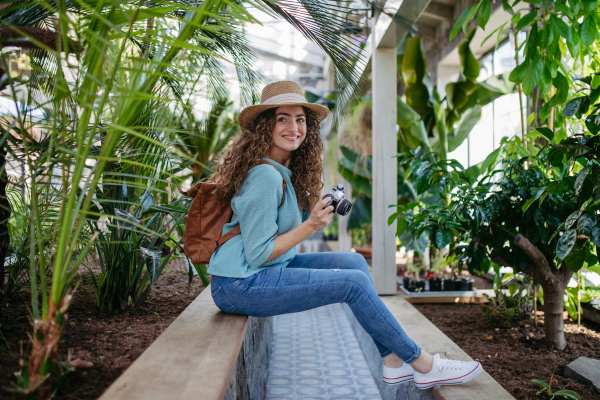 Portrait of young beautiful woman in botanical garden.