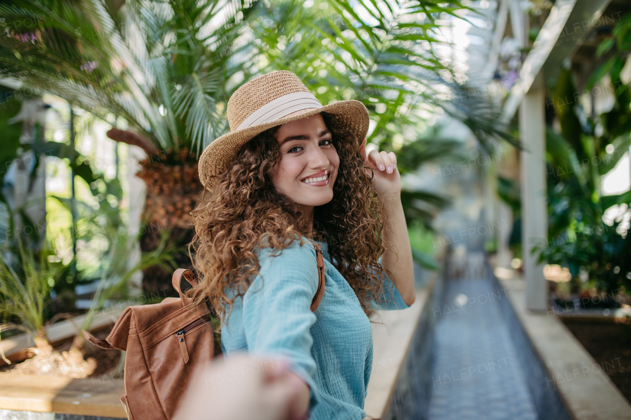 Portrait of young beautiful woman in botanical garden.