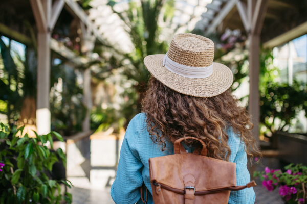 Portrait of young beautiful woman in botanical garden.