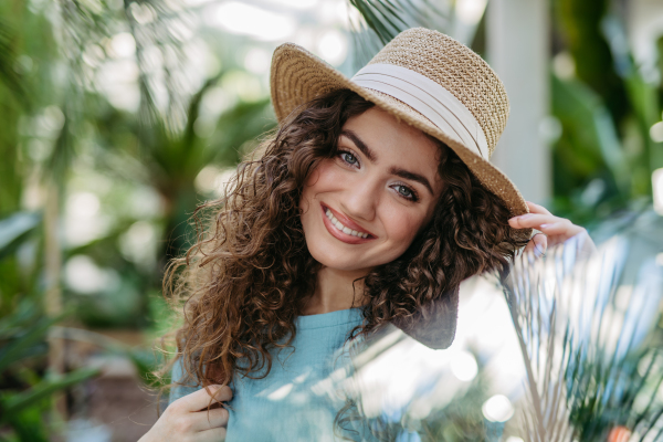 Portrait of young beautiful woman in botanical garden.