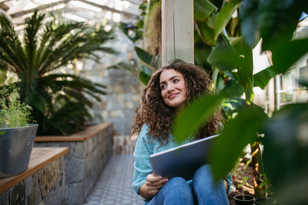 Portrait of young beautiful woman in botanical garden.