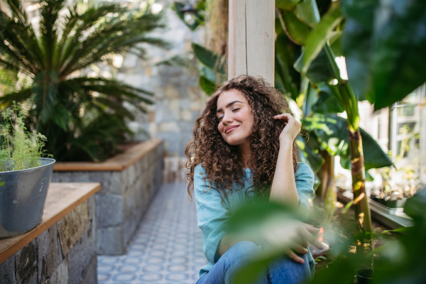 Portrait of young beautiful woman in botanical garden.