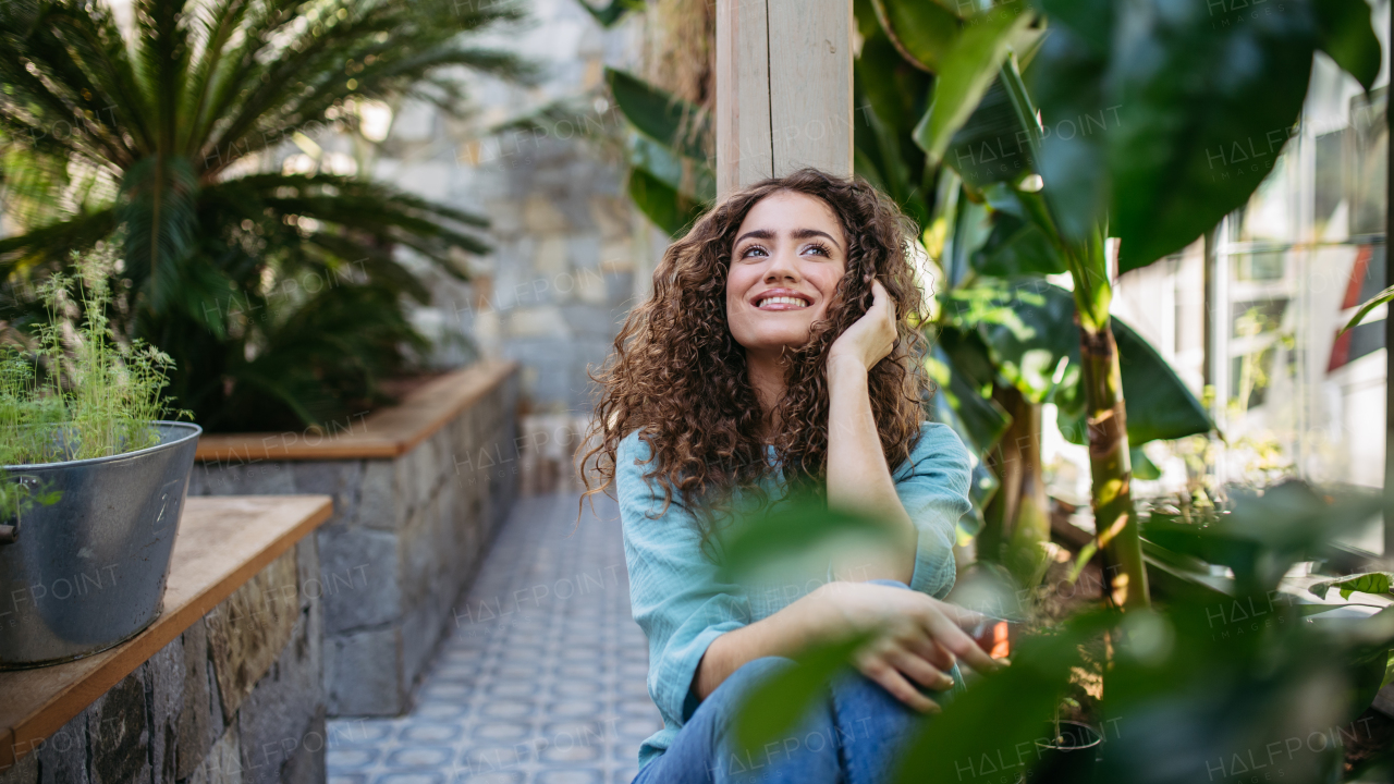 Portrait of young beautiful woman in botanical garden.