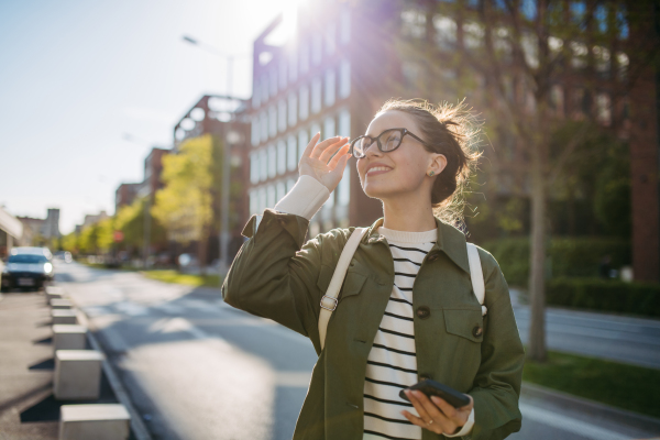 Portrait of a young woman walking in a city.