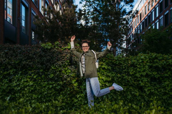 Portrait of young woman enjoying nature in a city park.