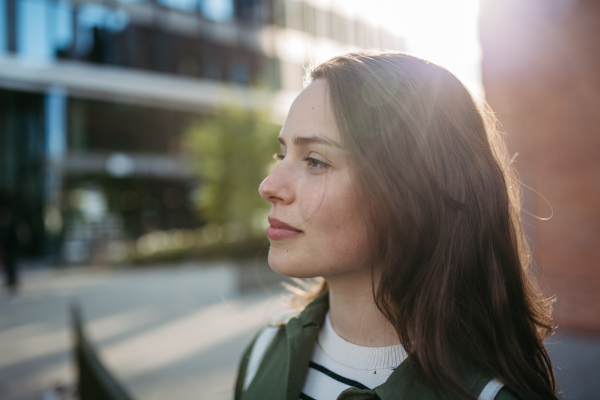 Portrait of a young woman in a city.