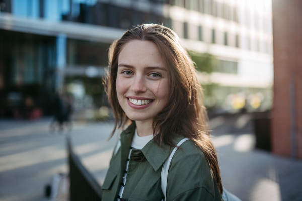 Portrait of a young woman in a city.