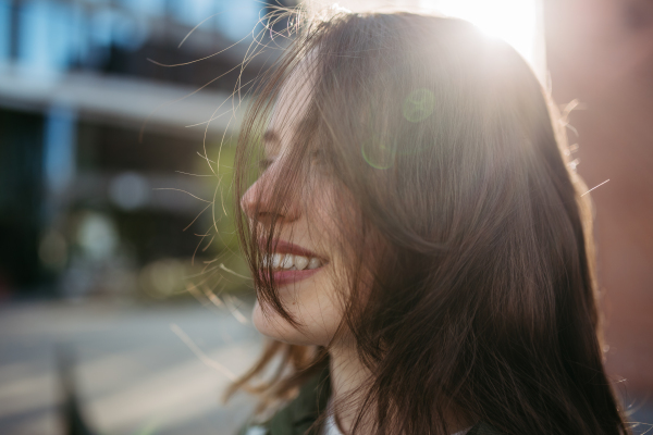 Portrait of a young woman in a city.