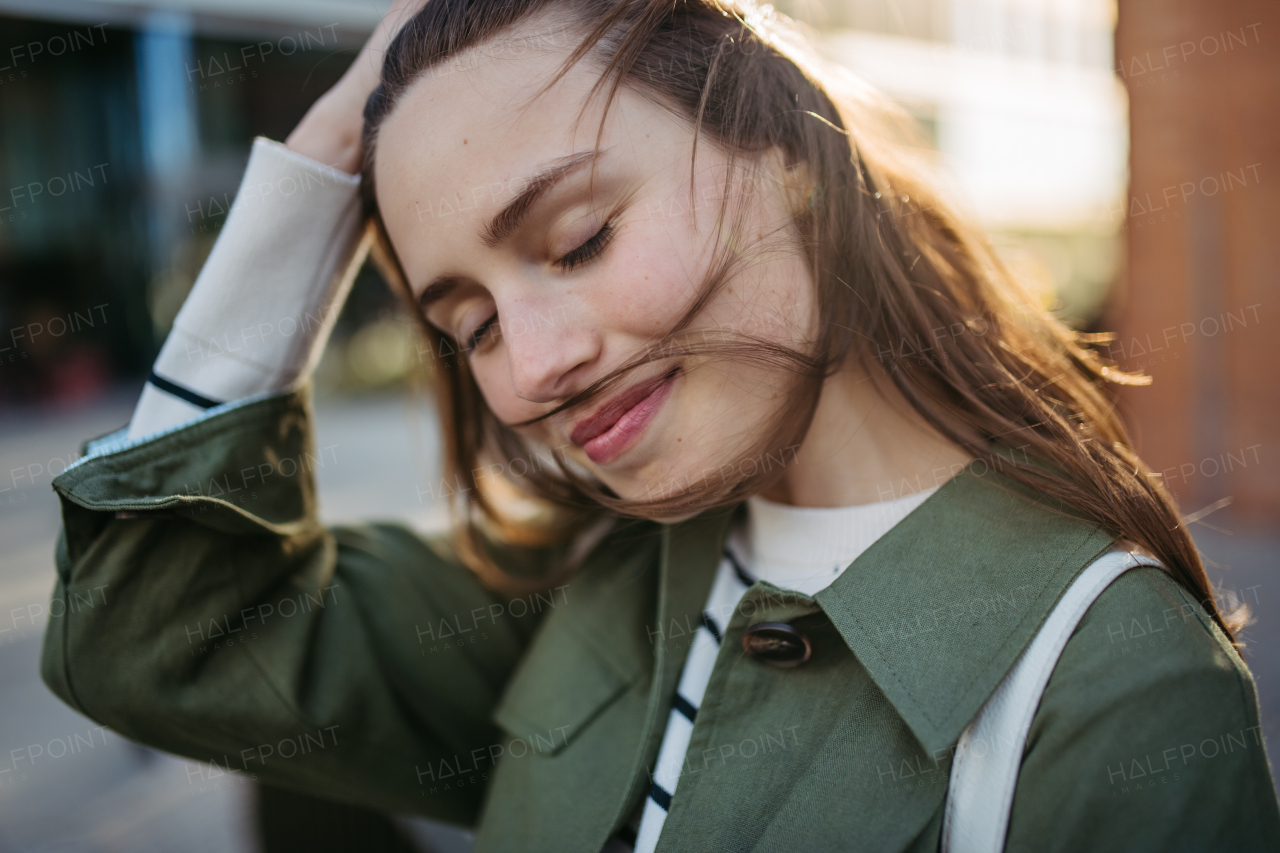 Portrait of a young woman in a city.