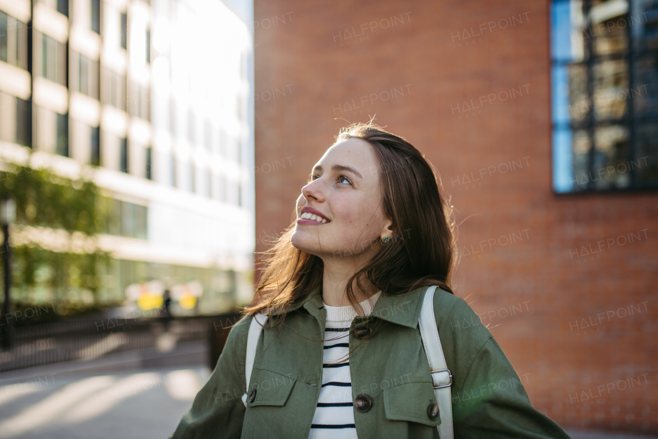 Portrait of a young woman in a city.