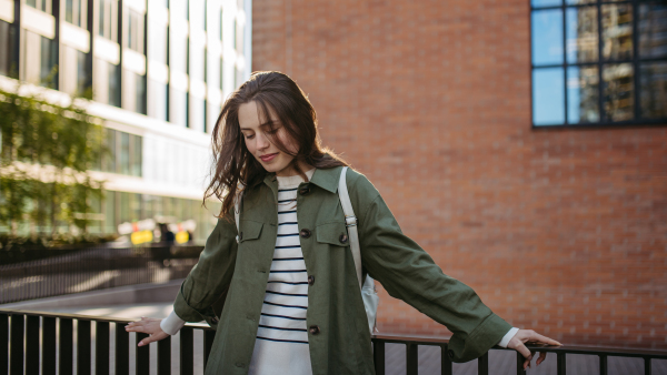 Portrait of a young woman in a city.