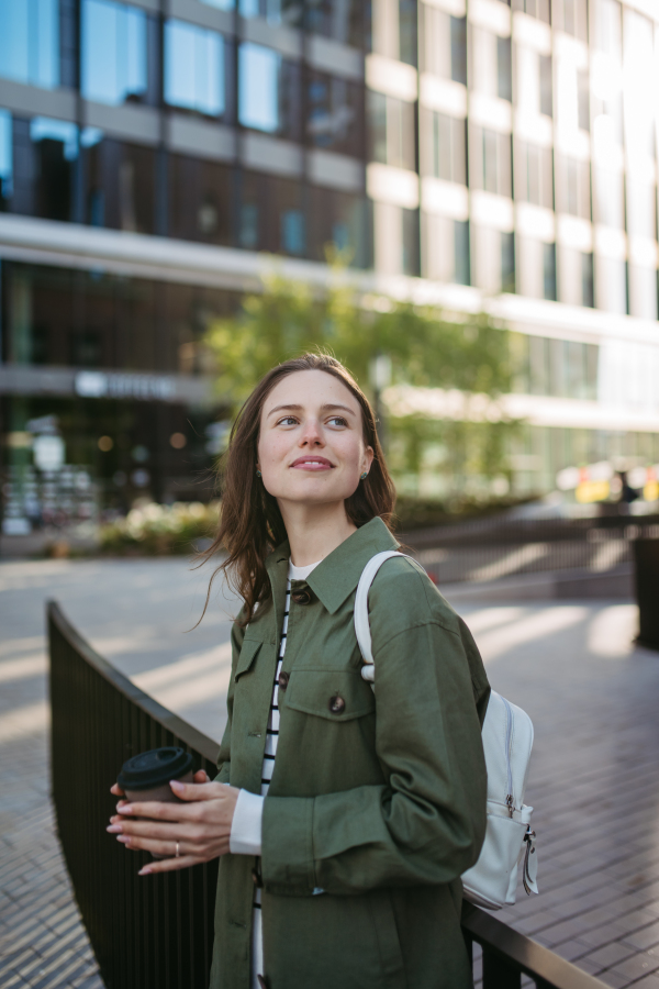 Portrait of a young woman in a city.