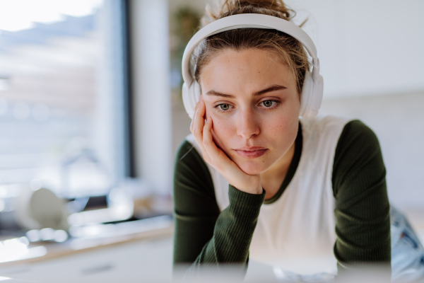 Portrait of young woman having homeoffice in a kitchen.