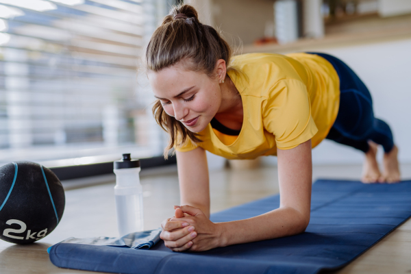 Young woman doing exercises at home.